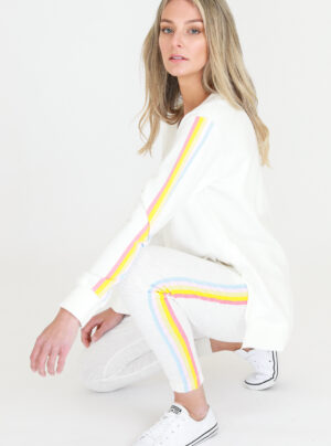 White sweater with yellow, blue and orange stripes down the sleeve