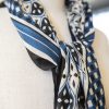 silk scarf with blue, black and white pattern and back tassels